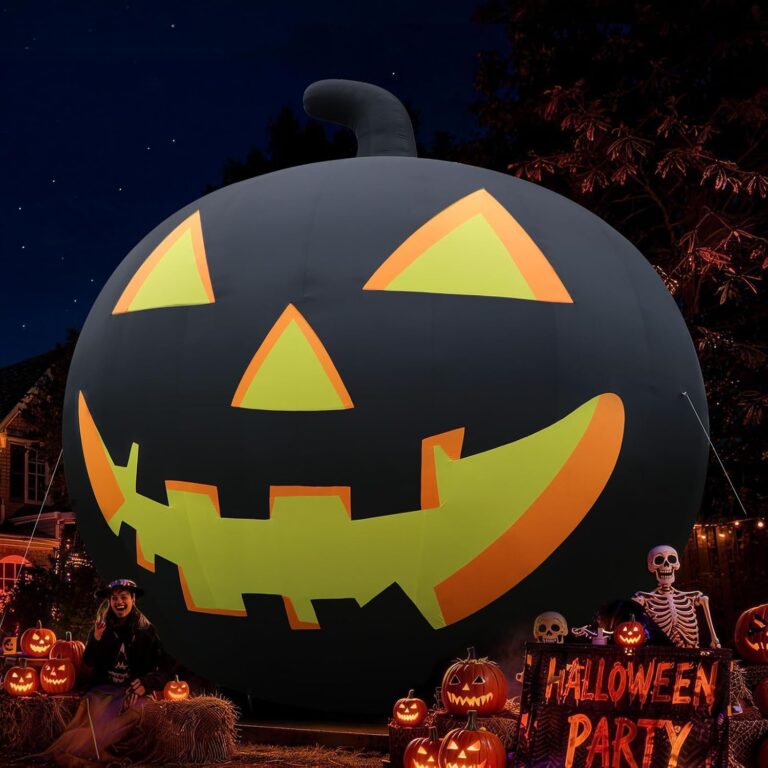 Inflatable jack-o-lantern in a decorated front yard at night